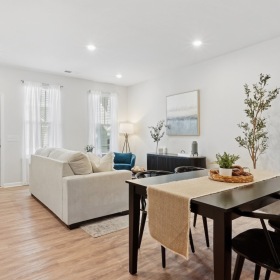 Spacious living areas to relax and unwind living room with a couch and a dining room with a table and chairs