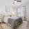 bedroom with a large window and lamps