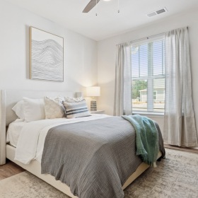 Bedroom options to fit every lifestyle bedroom with a large window and lamps