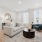 living room with large windows, a couch, chair, and coffee table