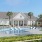 a house with a pool and palm trees