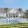 a house with a pool and palm trees